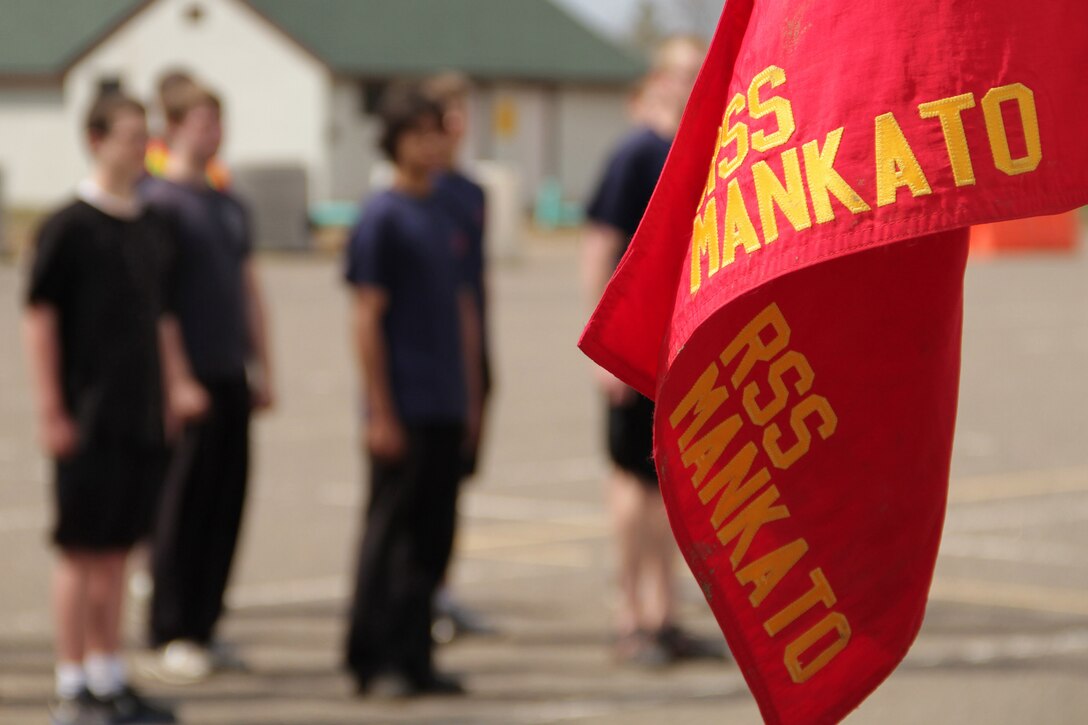 Members of the Delayed Entry Program out of the Mankato recruiting office wait for senior drill instructor Staff Sgt. Brody V. Goldthwaite, 27, from St. Charles, Ill., to deliver the next command while learning drill movements during the Recruiting Station Twin Cities mini boot camp May 7. The Mankato office brought 26 poolees and 12 guests to attend the three-day boot camp. For additional imagery from the event, visit www.facebook.com/rstwincities.