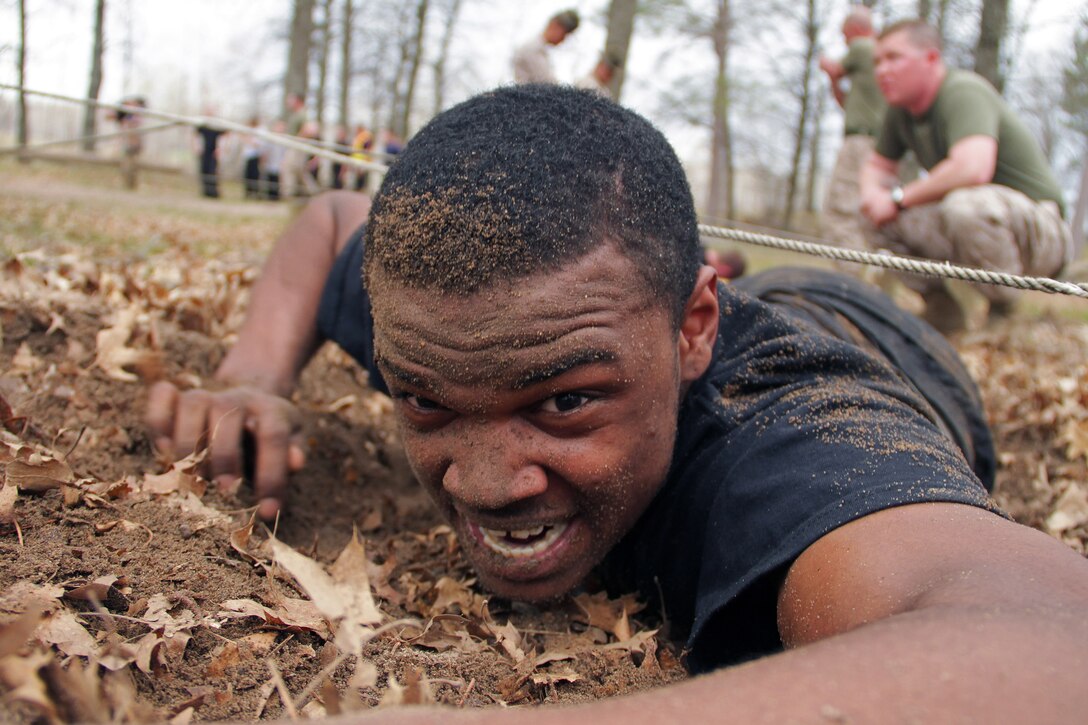Donald E. Pittman, 20, from Marshal, Minn., low crawls under wires while running through an obstacle course during the Recruiting Station Twin Cities mini boot camp May 7. Pittman, a Southwest Star Concept 2009 graduate who ships off to boot camp Dec. 12, was recruited out of the St. Cloud office by Sgt. Kirk P. Ryan. For additional imagery from the event, visit www.facebook.com/rstwincities.