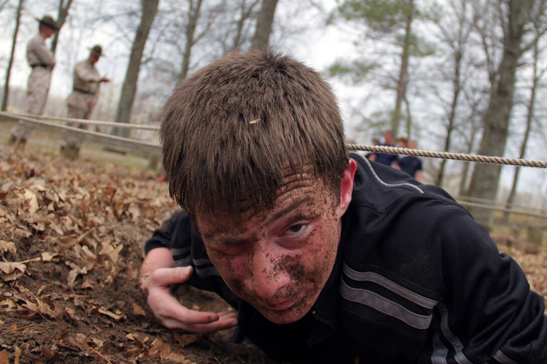 A guest with the St. Cloud recruiting office low crawls under ropes while running through an obstacle course during the Recruiting Station Twin Cities mini boot camp May 7. For additional imagery from the event, visit www.facebook.com/rstwincities.