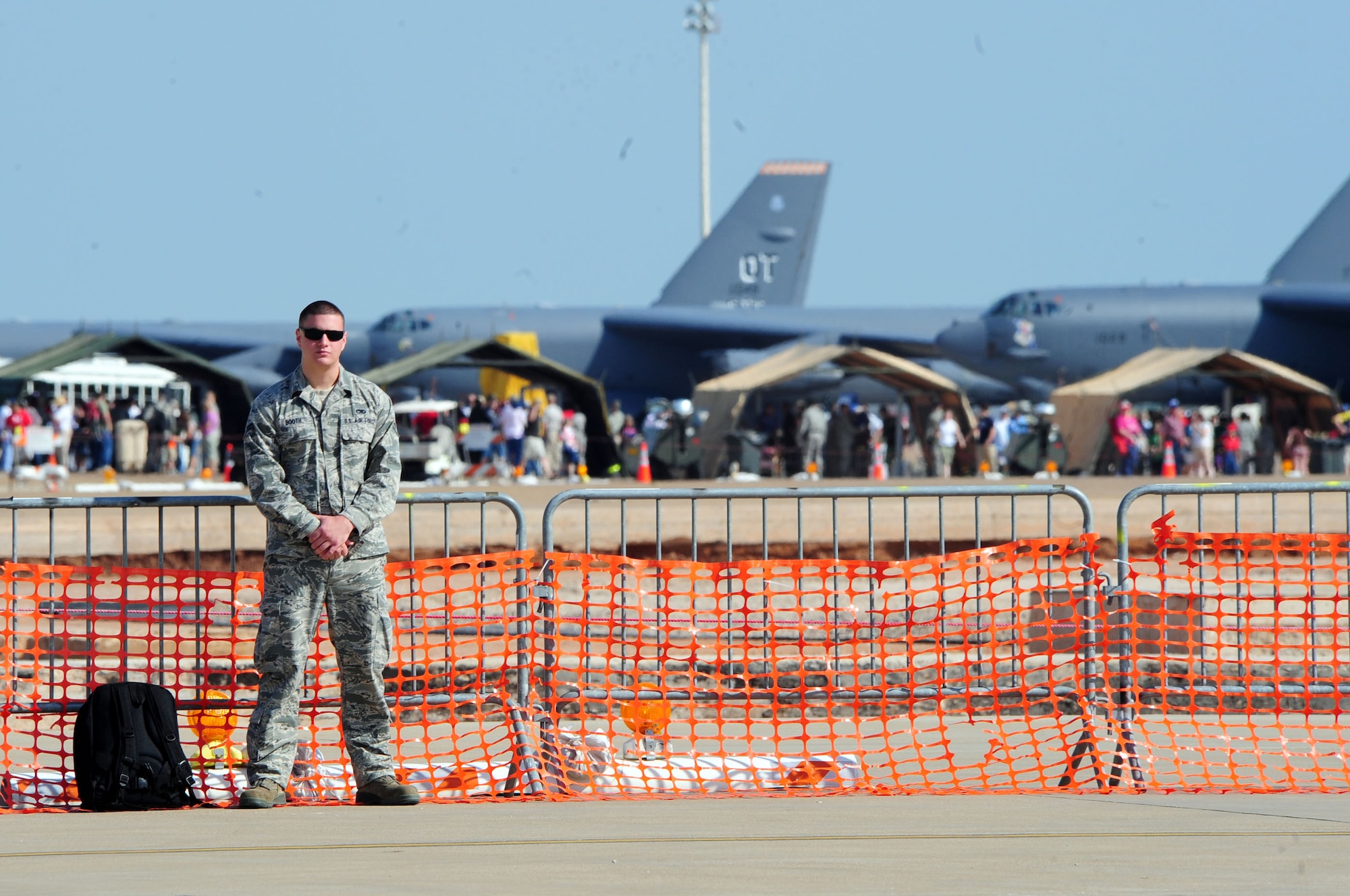 Airman 1st Class Michael Booth, 2nd Maintenance Squadron, stands guard over a security cordon during the 2011 Defenders of Liberty Air Show at Barksdale Air Force Base, La., May 7. More than 225,000 military, retiree and community members attended last year's show. (U.S. Air Force photo/Senior Airman Joanna M. Kresge)