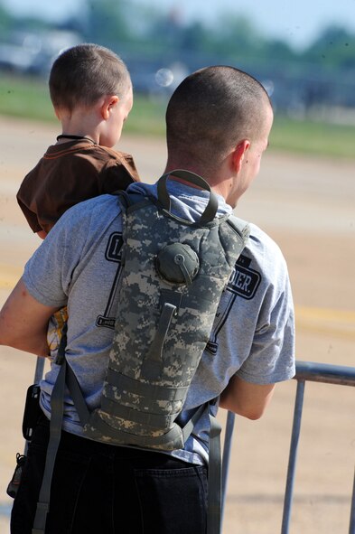 Army Spc. Mark Russell, 2-108th Calvalry at Fort Humbug in Shreveport, watches the aerial aerobatics of Gary Boucher during the 2011 Defenders of Liberty Air Show at Barksdale Air Force Base, La., May 7. More than 225,000 military, retiree and community members attended last year's show. (U.S. Air Force photo/Senior Airman Joanna M. Kresge)