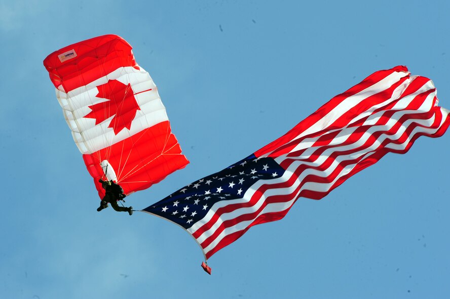 A member of the Canadian Forces Parachute Demo Team, The SkyHawks, floats to the ground with the American Flag during the opening ceremony of the Defenders of Liberty Air Show at Barksdale Air Force Base, La., May 7. The mission of The SkyHawks is to promote Canadian Forces at major events to inform the public of its trade and work environment by exemplifying a high standard of training, professionalism, teamwork and fitness. (U.S. Air Force photo/Senior Airman Joanna M. Kresge)