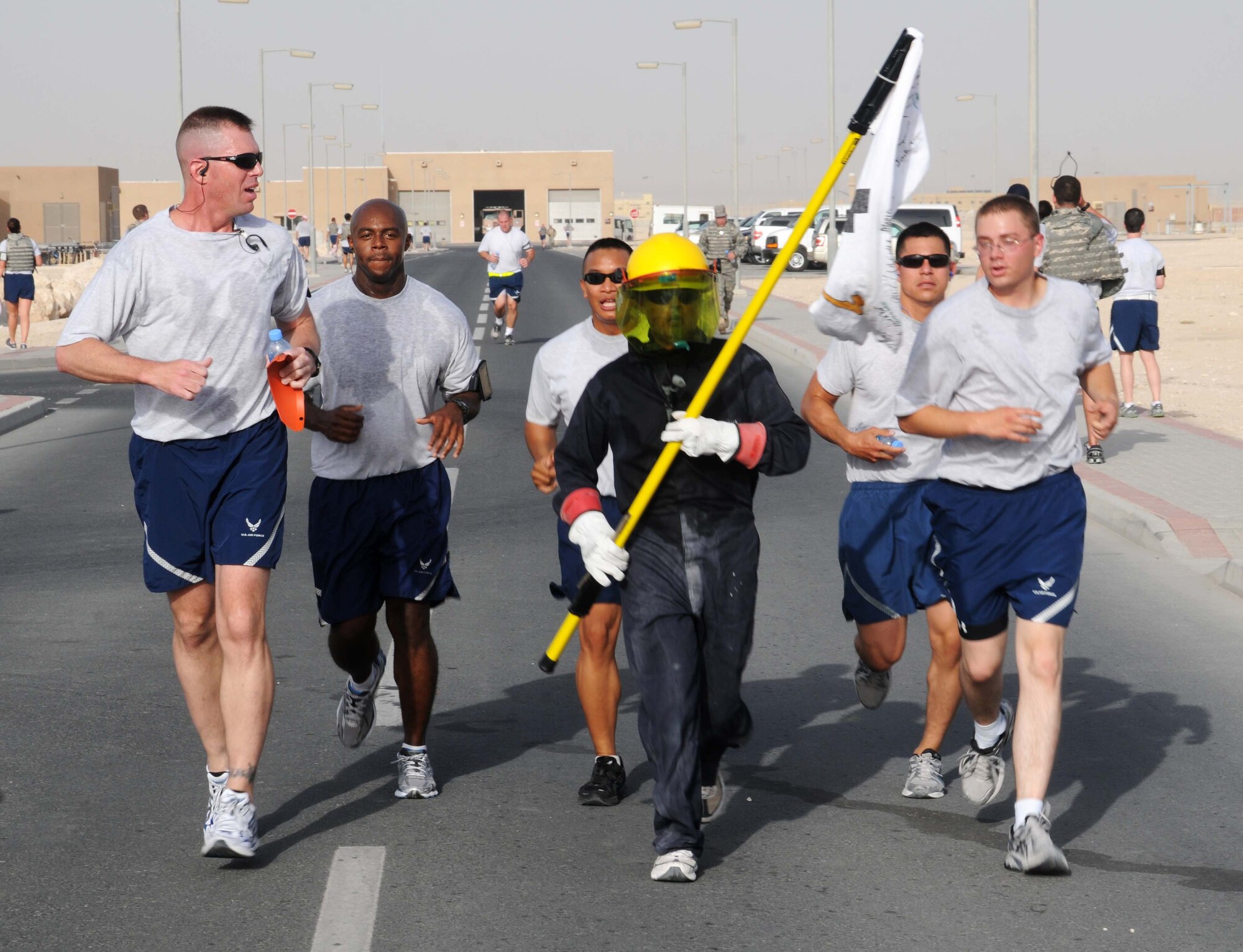 Airmen start the morning off with a 5 km run hosted by the 379th Expeditionary Civil Engineering Squadron Explosive Ordinance Disposal team May7 in Southwest Asia. Many servicemembers came to participate or cheer on the runners. (U.S. Air Force photo/ Staff Sgt Anthony Graham) 