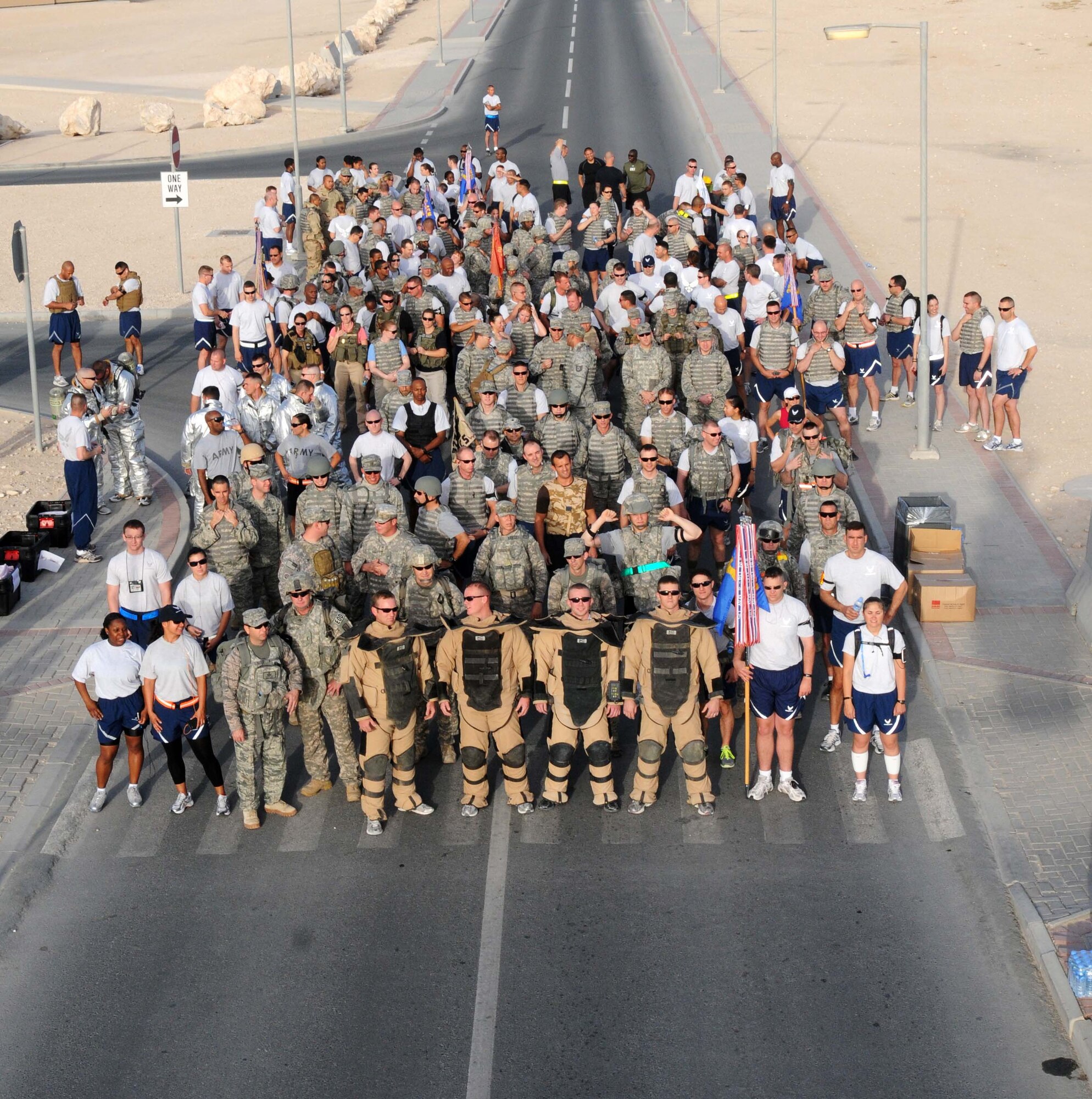 U.S. Servicemembers line up prior to the start of the 5 km run hosted by the 379th Expeditionary Civil Engineering Squadron Explosive Ordinance Disposal team May7 in Southwest Asia.  Many servicemembers came to participate or cheer on the runners. (U.S. Air Force photo/ Staff Sgt Anthony Graham) 