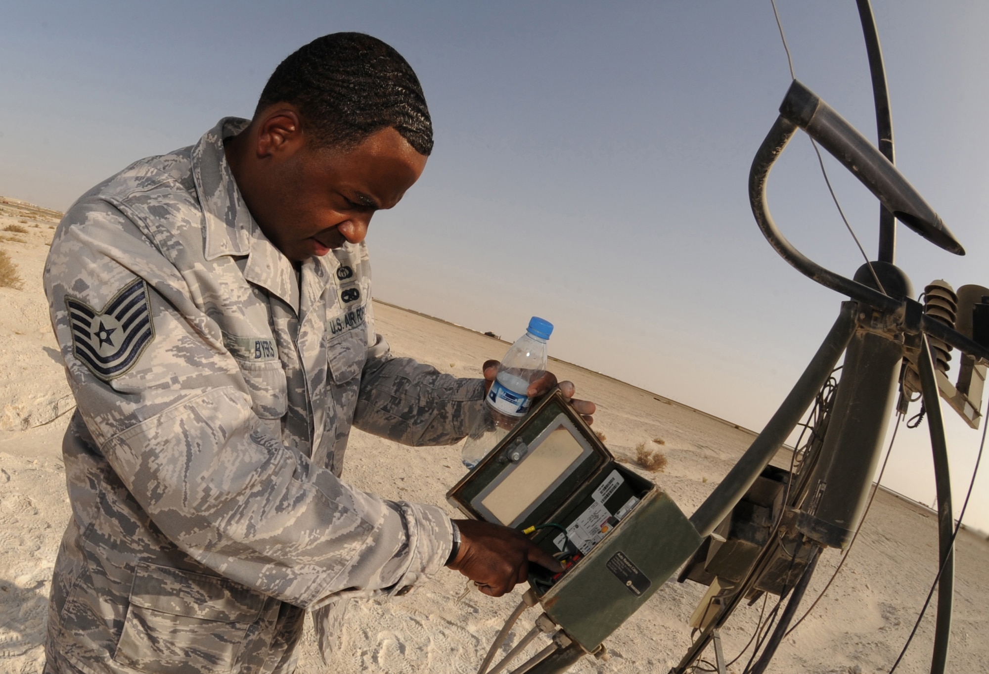 Tech. Sgt. Shannon Byers, 380th Expeditionary Operations Support Squadron, checks the transient/surge protector sacrifice indicators on an AN/TMQ-53 Tactical Meteorological Observing System during a preventative maintenance inspection Mar. 11, 2011. The basic system configuration measures surface pressure, temperature, dew point, wind direction and speed, and liquid precipitation. (U.S. Air Force photo by Senior Airman Maynelinne De La Cruz)