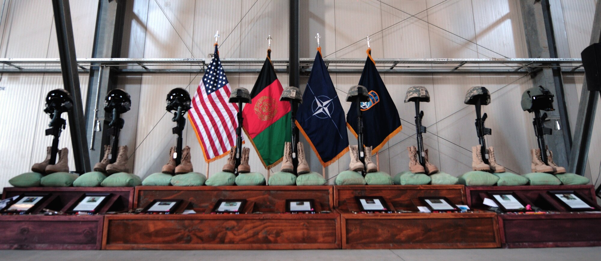KABUL, Afghanistan – The symbolic displays of combat boots, inverted rifles, helmets and dog tags were on display during a memorial service for eight Airmen and one retired Army civilian contractor killed April 27 when a gunman opened fire during a meeting.   (U.S. Air Force Photo by Tech. Sgt. Brian Christiansen)
