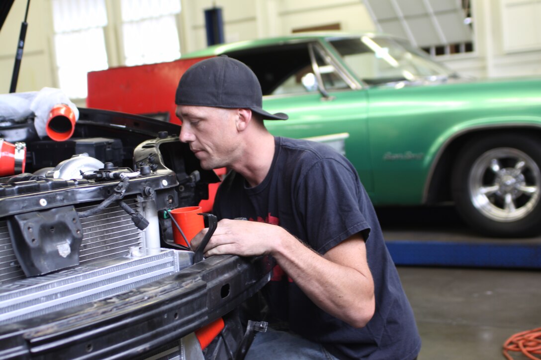 Seaman Justin Merrill, a sonar technician with Naval Base Point Loma, builds a custom turbo set-up for a Hyundai Tiburon May 7 at the Auto Skills Center aboard Marine Corps Recruit Depot San Diego. Servicemembers can use the center's facilities and tools to work on their own vehicles.