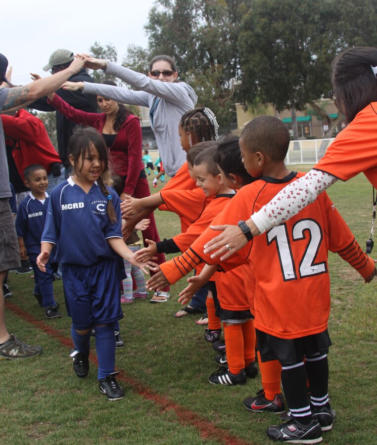 The children shake hands with each other after a soccer match May 7 at Marine Corps Recruit Depot San Diego. This helps promote good sportsmanship between competing teams.