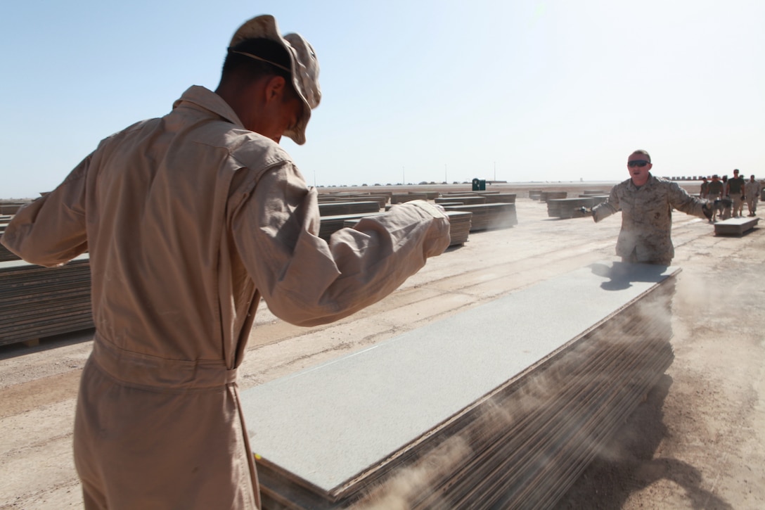 Marines with Marine Wing Support Squadron 272 pick up the remaining pieces of aluminum matting that was the expeditionary runway at Camp Bastion, Afghanistan, May 8. The Marines picked up more than 1.8 million square feet of aluminum matting during the project. An 11,500-foot permanent runway opened at Camp Bastion Feb. 11, which allowed the expeditionary runway to be removed.