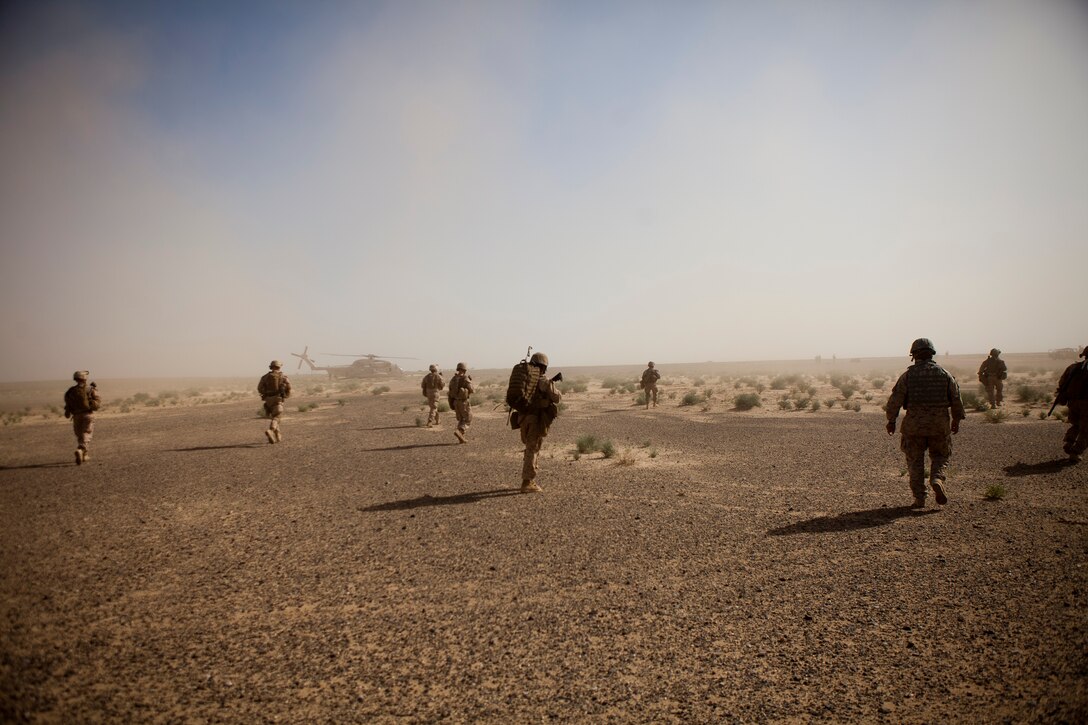 Coalition forces walk toward suspicious vehicles to search for drugs and possible threats in southwestern Afghanistan, May 8. The Marines supported efforts to disrupt enemy freedom of movement as well as counteract enemy drug and weapons trafficking in efforts to support Operation Enduring Freedom.