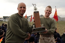 Gunnery Sgt. Ferass Ahmad, Recruiting Substation Roseville, accepts the championship trophy for best office from Recruiting Station Twin Cities Sgt. Maj. James Kirkland, 44, from Mendota Heights, Minn., during the RS Twin Cities mini boot camp awards ceremony May 8. Ahmad, 31, from Brooklyn, N.Y., is the noncommissioned officer in charge of the Roseville office. For additional imagery from the event, visit www.facebook.com/rstwincities.