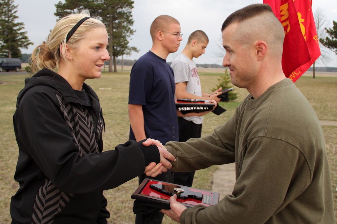 Katie Erwin, an 18-year-old senior at Owatonna High School, receives the Recruiting Substation Mankato Gung-Ho Poolee Award from Recruiting Station Twin Cities Commanding Officer Maj. Kenneth Gawronski, a 35-year-old Liberty, Mo., native. Erwin, the only woman out of 38 people from the Mankato office who attended mini boot camp, ships off to Parris Island, S.C., on July 11.