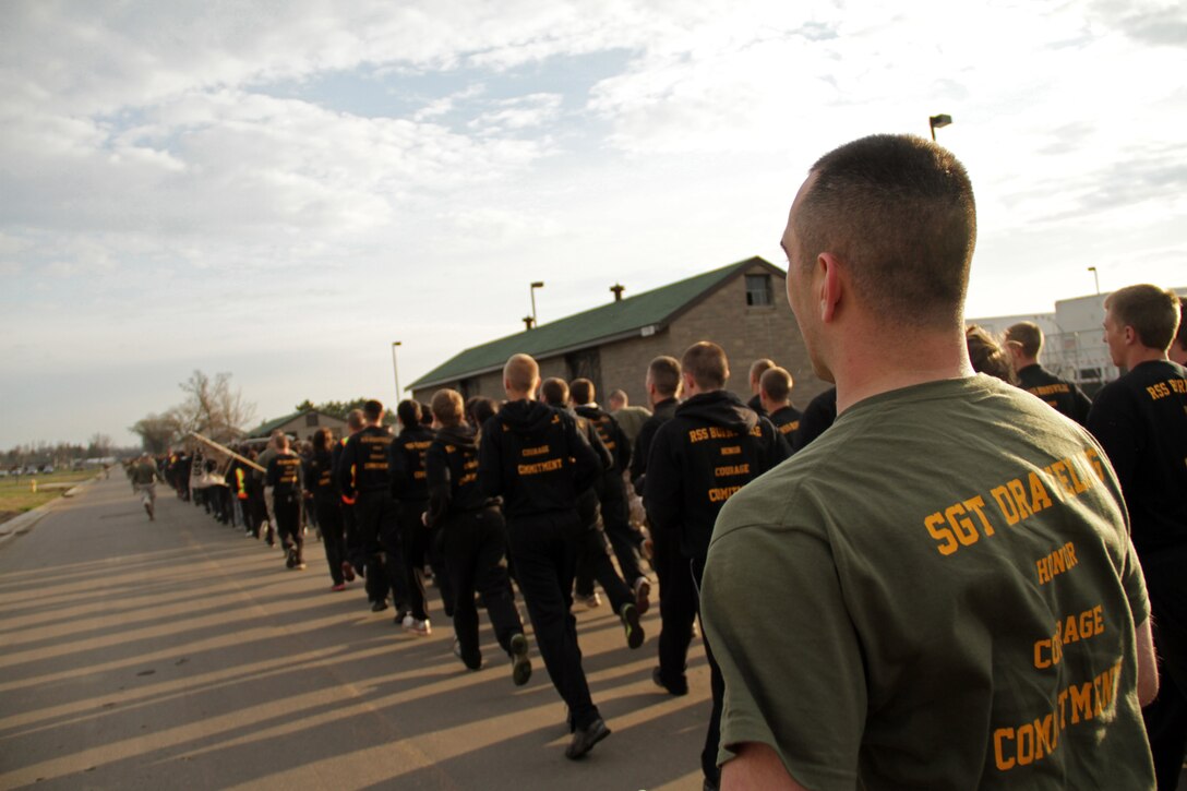 Recruiter Sgt. Joshua Draveling, 26, from Milwaukee, Wis., runs alongside more than 50 high school and college students during the Recruiting Station Twin Cities mini boot camp moto run May 8. The Burnsville office brought 56 people to the three day training evolution. For additional imagery from the event, visit www.facebook.com/rstwincities.