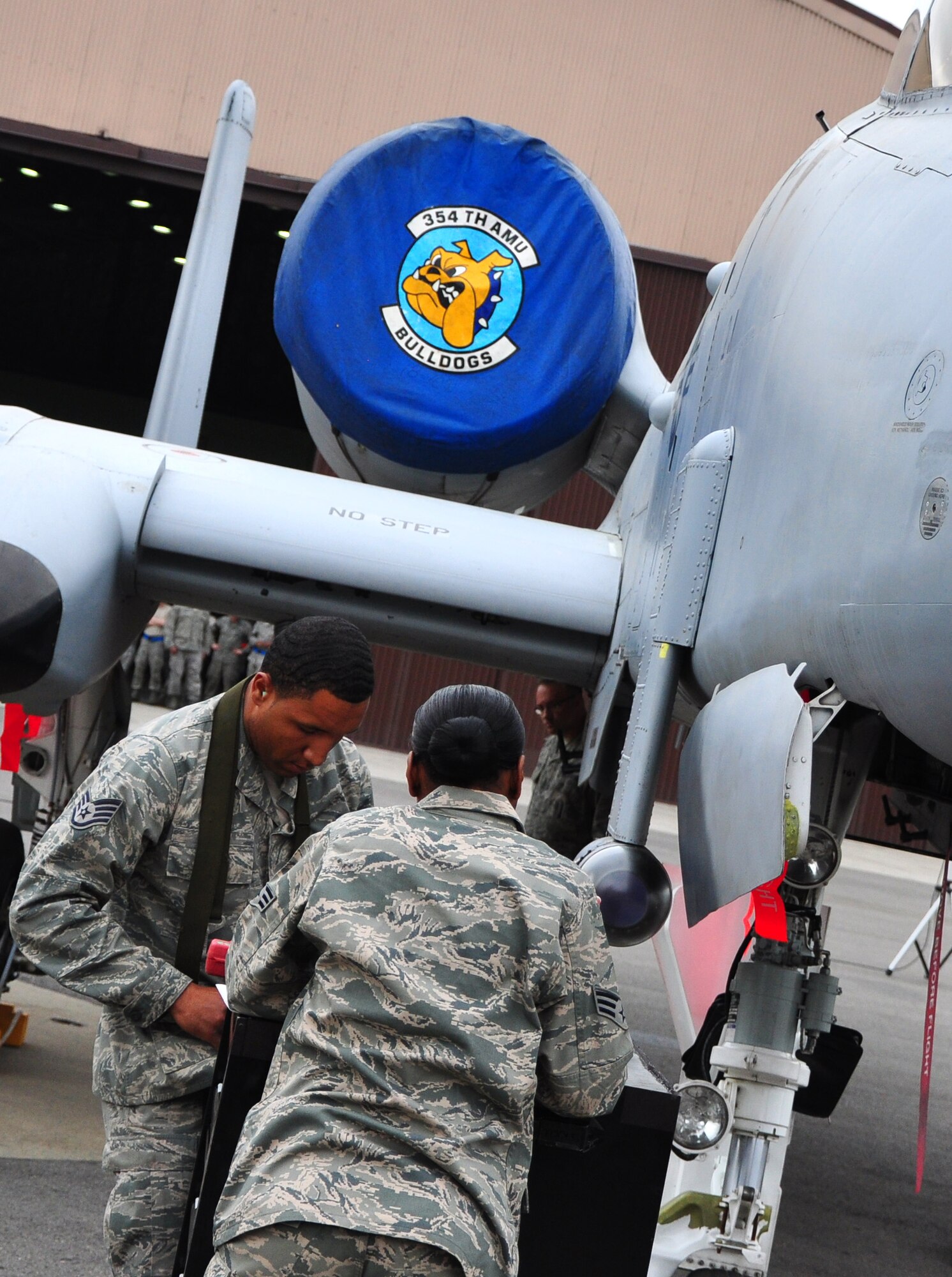 Three weapon load crews clashed May 6 during a quarterly weapon load competition here. Airmen from the 25th Aircraft Maintenance Unit, 36th AMU and 354th Expeditionary Fighter Squadron competed head-to-head loading a Mark-82 general purpose bomb, a CBU-87 air-delivered cluster weapon system and an AIM-9 Sidewinder air-to-air missile during the timed portion of the event. The competition also included a written test and a standards test. (U.S. Air Force photo/Staff Sgt. Chad Thompson)
