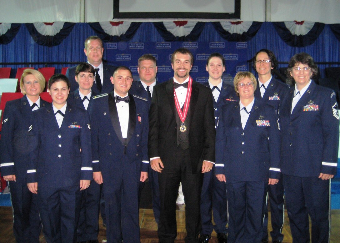 The 2011 Ellis Island Award Ceremony honored SSgt Salvatore Giunta, pictured with the band.  He is the first living person to receive the United States Armed Forces' highest decoration for valor, the Medal of Honor, for actions that occurred since the Vietnam War. Giunta was cited for saving the lives of members of his squad on October 25, 2007 during the War in Afghanistan. (MA ANG Photo/MSgt Thomas Moriarty)