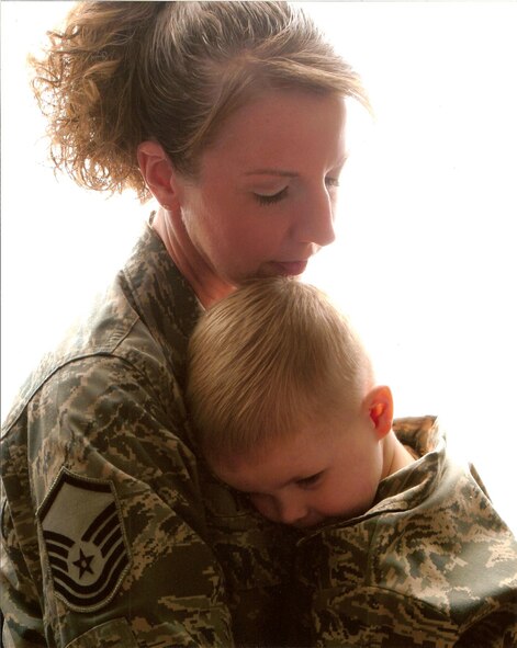 Master Sgt. Brenda Yoder hugs her son, Braden, the day before
she deployed to Southwest Asia as the Air Traffic Control chief controller
for the 379th Expeditionary Operations Support Squadron at an undisclosed
air base. Sergeant Yoder is deployed from the 436th Operations Support
Squadron at Dover AFB, Del. (Courtesy photo)
