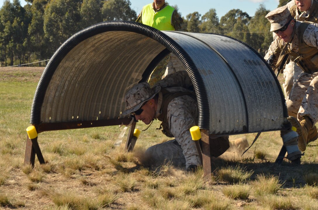 Staff Sgt. Benjamin Robinson, assistant staff non-commissioned officer in charge, electrical shop, Marine Aviation Logistics Squadron 36, Marine Aircraft Group 36, 1st Marine Air Wing, III Marine Expeditionary Force, moves through an obstacle May 9 during the 2011 Australian Army Skill at Arms Meeting.  The meeting is an annual, international combat-marksmanship competition hosted by the Australian Army that will run through May 19.  (U.S. Marine Corps Photo by Lance Cpl. Mark W. Stroud/Released)