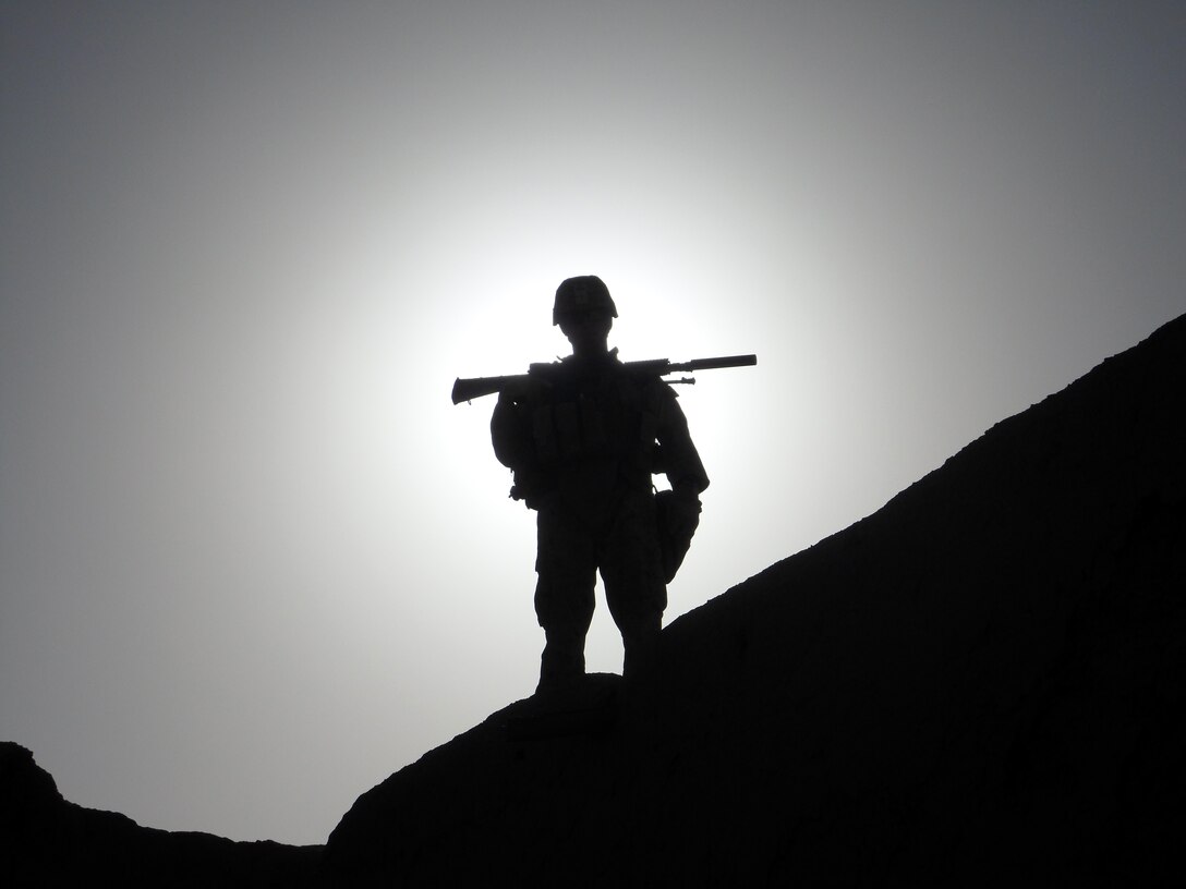 Pfc. Brad G. Hill, a designated marksman with 2nd Platoon, Company C, 1st Battalion, 5th Marine Regiment, stands post overlooking part of the Sangin River Valley from a compound outside of Patrol Base Fulod, Sangin, Afghanistan, May 9. Hill, the Marines of 2nd Platoon and Afghan National soldiers held security for the night as part of their listening and observation post. Hill, 26, is from Boise, Idaho.