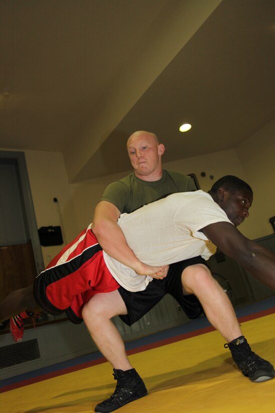 Lance Cpl. Steven T. Smiley lifts Cpl. Donte L. Ravenell during their practice in the wrestling room aboard Marine Corps Base Camp Lejeune May 9. Smiley is the only Cherry Point Marine on the All-Marine wrestling team. “When I see one of my teammates on the mat slamming guys around it pushes me to do that much better,” said Smiley.