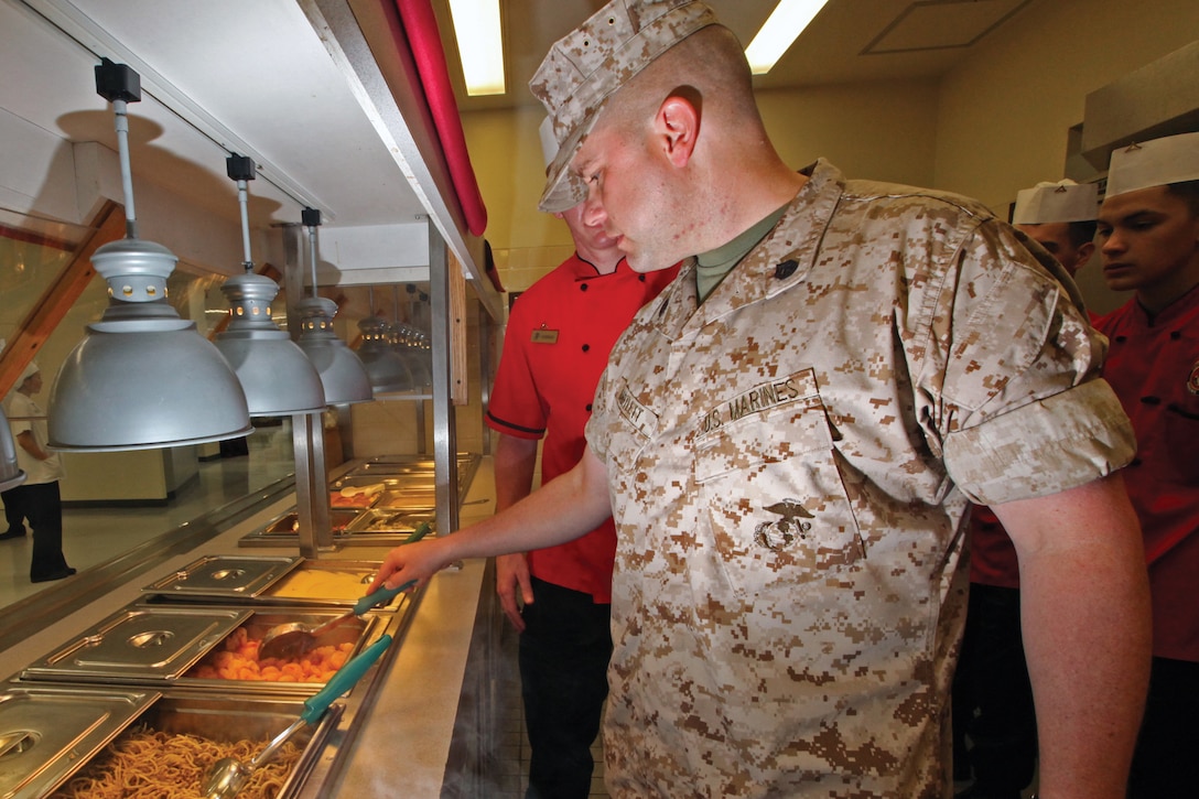 Staff Sgt. Donald A. Bartlett, Camp Schwab mess hall manager, 4th Marine Regiment, 3rd Marine Division, III Marine Expeditionary Force, performs a line inspection before opening the mess hall May 5. Before every meal a line inspection is performed to ensure the food is prepared correctly and ready to serve. Bartlett has been recognized as the Marine Corps’ 2011 staff noncommissioned officer food service specialist of the year.