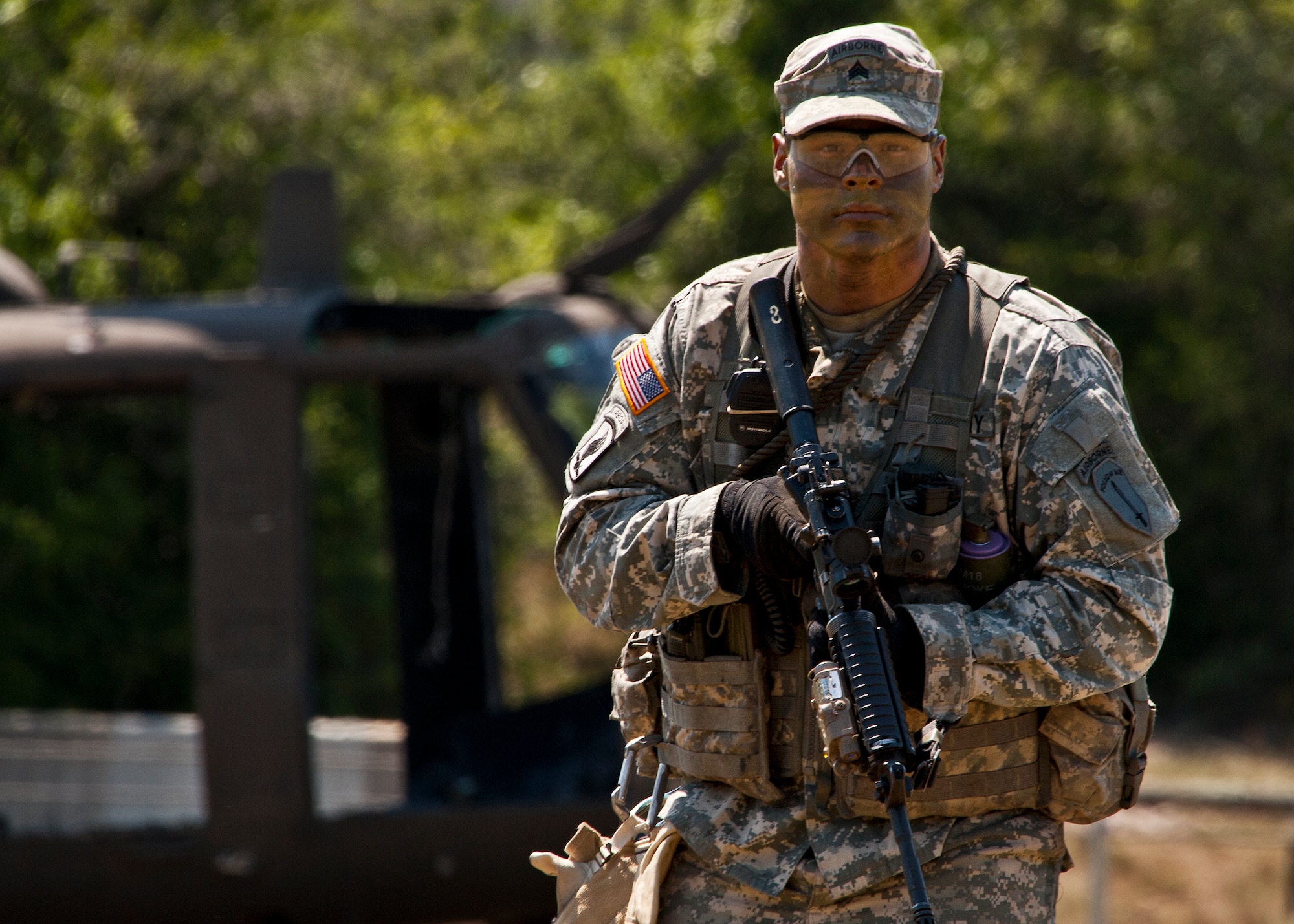 EGLIN AIR FORCE BASE, Fla. -- An Army Ranger stands in front of a helicopter at the 6th Ranger Training Battalion during the their 60th Anniversary Open House event, May 7.  The event was a chance for the public to learn how Rangers train and operate in extreme situations. The event displays showed dive equipment, weapons, a reptile zoo and zodiac boats.  The demonstrations showed off hand-to-hand combat, a parachute jump, a down-pilot scenario and others. (U.S. Air Force photo/Samuel King Jr.) 