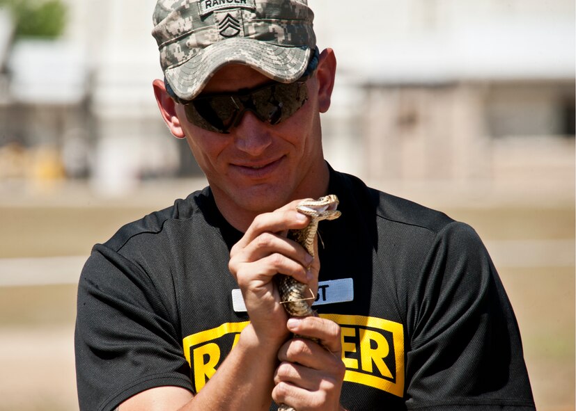EGLIN AIR FORCE BASE, Fla. -- An Army Ranger snake handler shows off one of the many poisonous snakes the 6th Ranger Training Battalion encounters training on Eglin ranges during their 60th Anniversary Open House event, May 7.  The event was a chance for the public to learn how Rangers train and operate in extreme situations. The event displays showed dive equipment, weapons, a reptile zoo and zodiac boats.  The demonstrations showed off hand-to-hand combat, a parachute jump, a down-pilot scenario and others. (U.S. Air Force photo/Samuel King Jr.)   