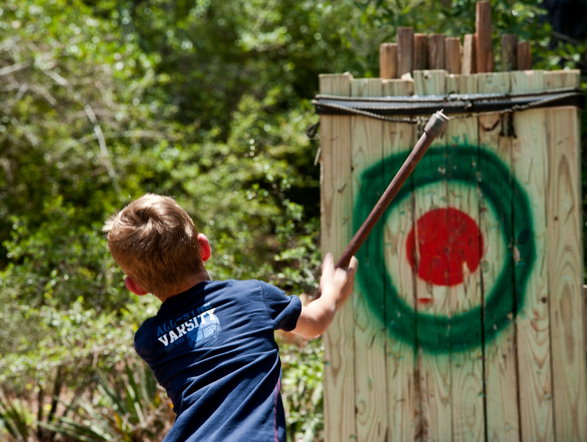 EGLIN AIR FORCE BASE, Fla. -- A young "Ranger" tries to hit the bullseye with a hatchet during the 6th Ranger Training Battalion's 60th Anniversary Open House event, May 7.  The event was a chance for the public to learn how Rangers train and operate in extreme situations. The event displays showed dive equipment, weapons, a reptile zoo and zodiac boats.  The demonstrations showed off hand-to-hand combat, a parachute jump, a down-pilot scenario and others. (U.S. Air Force photo/Samuel King Jr.) 