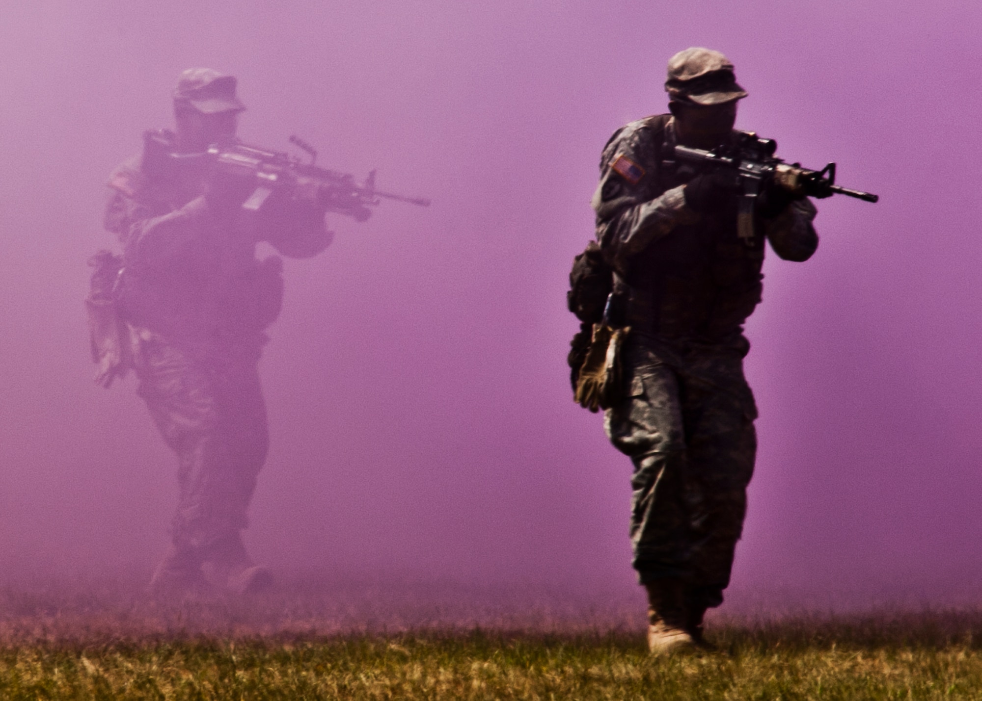 An Army Ranger squad passes through a smoke screen during the 6th Ranger Training Battalion's  60th Anniversary Open House event, May 7.  The event was a chance for the public to learn how Rangers train and operate in extreme situations. The event displays showed dive equipment, weapons, a reptile zoo and zodiac boats.  The demonstrations showed off hand-to-hand combat, a parachute jump, a down-pilot scenario and others. (U.S. Air Force photo/Samuel King Jr.) 