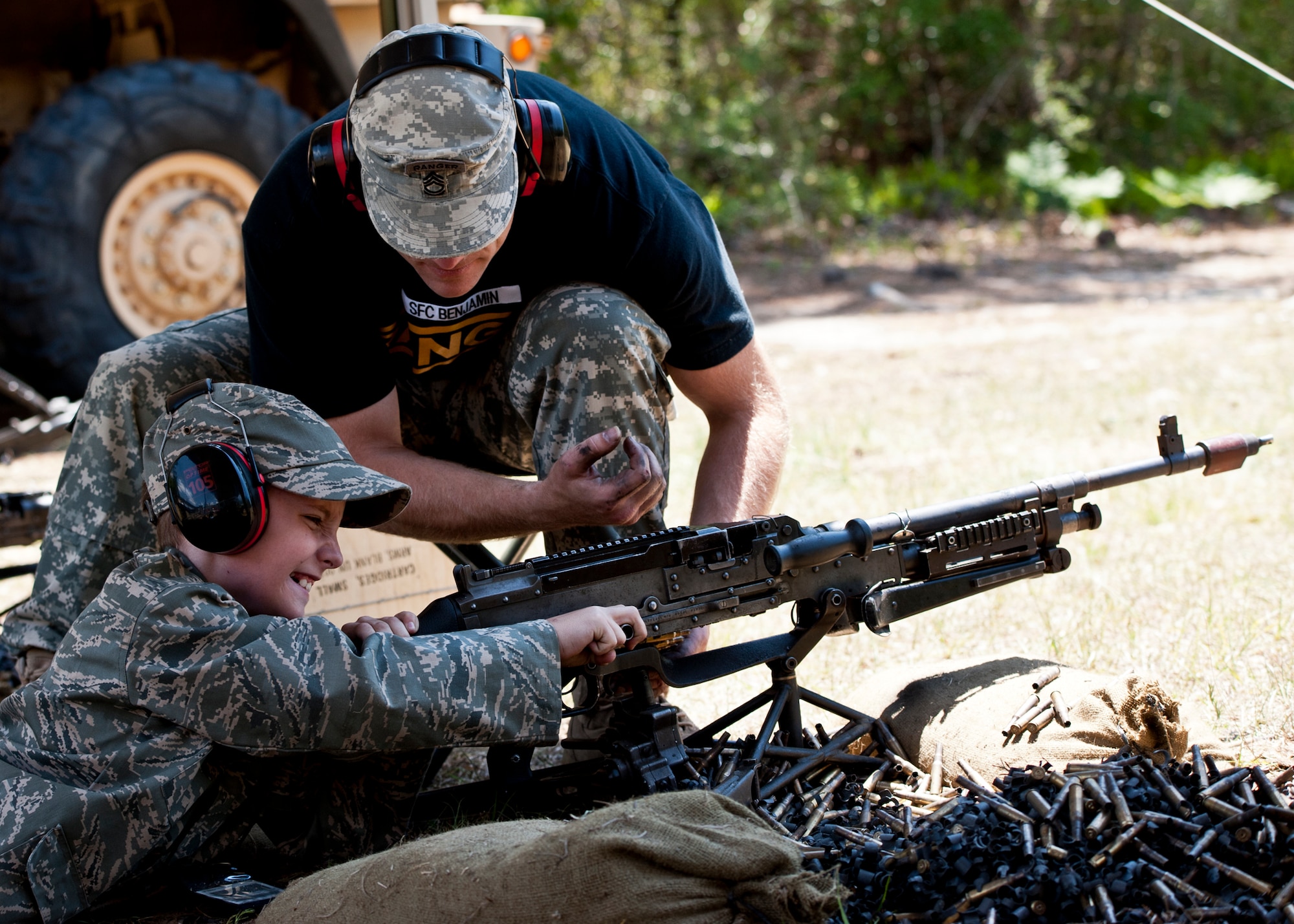 EGLIN AIR FORCE BASE, Fla. -- Sgt. 1st Class Jason Benjamin, 6th Ranger Training Battalion, shows a "new recruit" how to clear the chamber of an M-249 assault rifle during their 60th Anniversary Open House event, May 7.  The event was a chance for the public to learn how Rangers train and operate in extreme situations. The event displays showed dive equipment, weapons, a reptile zoo and zodiac boats.  The demonstrations showed off hand-to-hand combat, a parachute jump, a down-pilot scenario and others. (U.S. Air Force photo/Samuel King Jr.)  