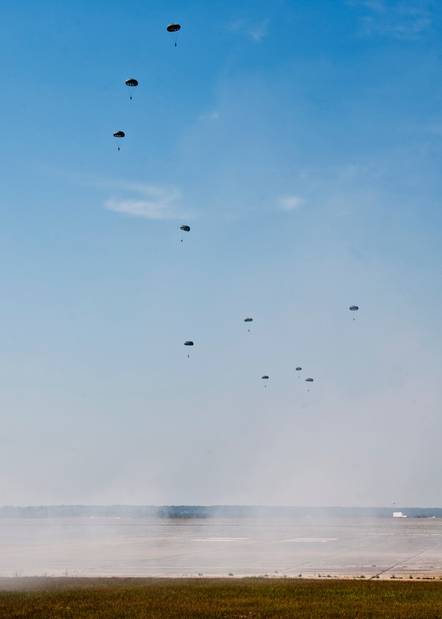 6th Ranger Training Battalion Rangers parachute down after leaping from a C-130 during the  their 60th Anniversary Open House event, May 7.  The event was a chance for the public to learn how Rangers train and operate in extreme situations. The event displays showed dive equipment, weapons, a reptile zoo and zodiac boats.  The demonstrations showed off hand-to-hand combat, a parachute jump, a down-pilot scenario and others. (U.S. Air Force photo/Samuel King Jr.) 