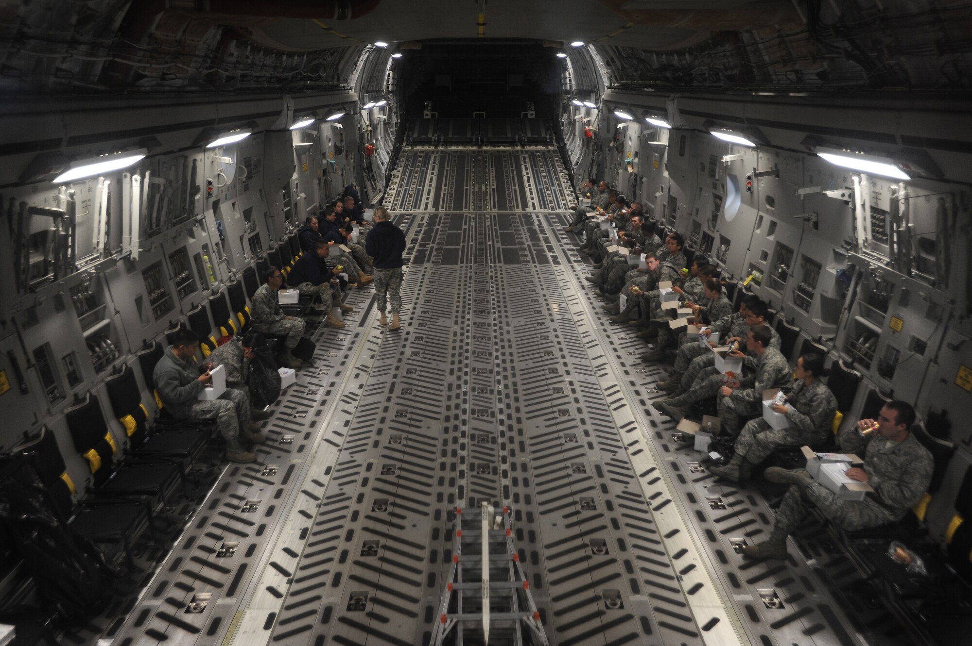 Reserve Officer Training Corps cadets enjoy boxed lunches in the back of a C-17 belonging to the 535th Airlift Squadron May 6. During the flight the cadets witnessed the Hawaiian Islands from the air out the back of the C-17 while in flight. (U.S. Air Force photo/Senior Airman Lauren Main)