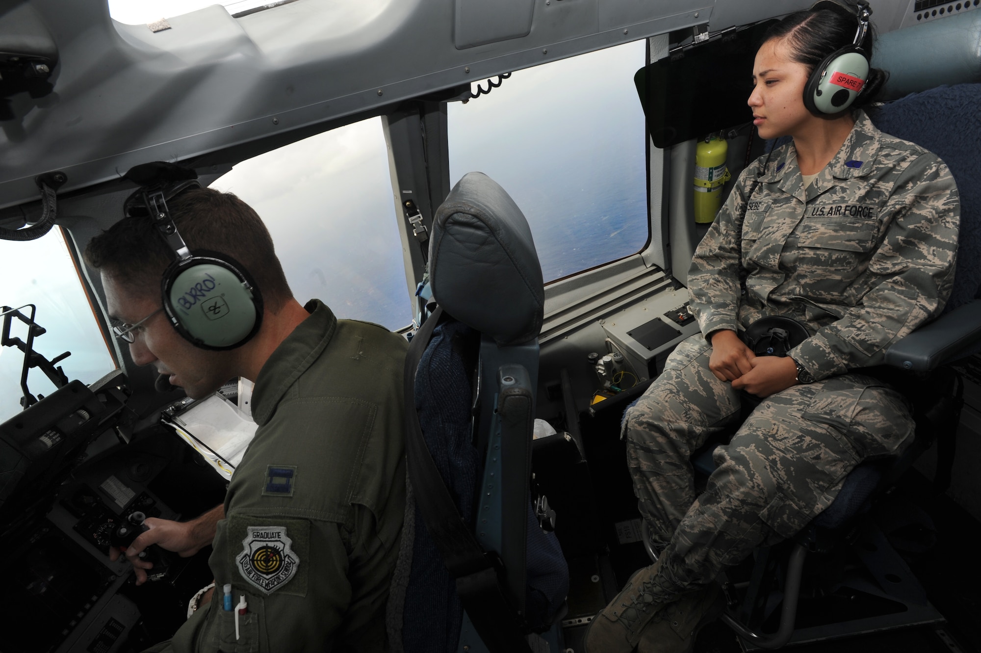 Capt. David Morales, C-17 pilot with the 535th Airlift Squadron, and Cadet Jody Hesebe, ROTC cadet with University of Hawaii, enjoy the scenic views of the Hawaiian Islands from the air. The flight contained more than 40 ROTC cadets from U.H. who were able to witness an in-air refueling by a KC-135. (U.S. Air Force photo/Senior Airman Lauren Main)