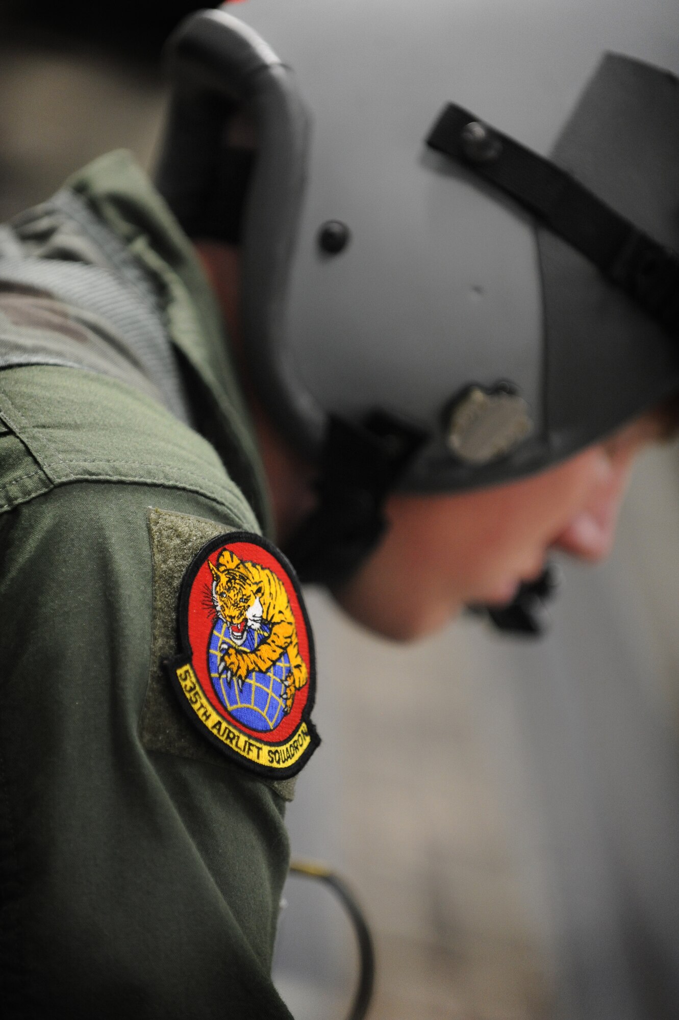 Airman 1st Class Kevin Spears, loadmaster with the 535th Airlift Squadron sits ready to experience the ultimate thrill ride on a C-17 and  walk to the edge of the ramp in harness May 6. The flight contained more than 40 Reserve Officer Training Corps students from the University of Hawaii. During the flight, the cadets were able to witness an in air refueling and the islands of Hawaii from the back of a C-17. (U.S. Air Force photo/Senior Airman Lauren Main)