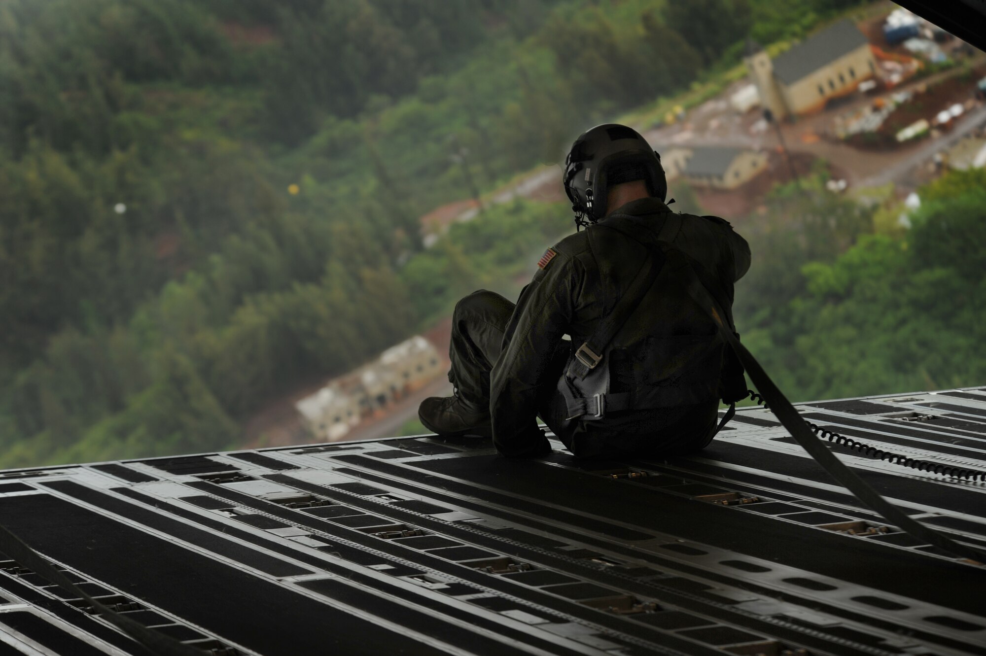 Staff Sgt. Philip Valenta, loadmaster with the 535th Airlift Squadron, sits in the dropped ramp of a C-17 while flying over the north shore of Oahu May 6. The flight contained more than 40 Reserve Officer Training Corps cadets who were able to witness the scenic aerial views of Hawaii as well as an in-filght refueling over the pacific. (U.S. Air Force photo/Senior Airman Lauren Main)