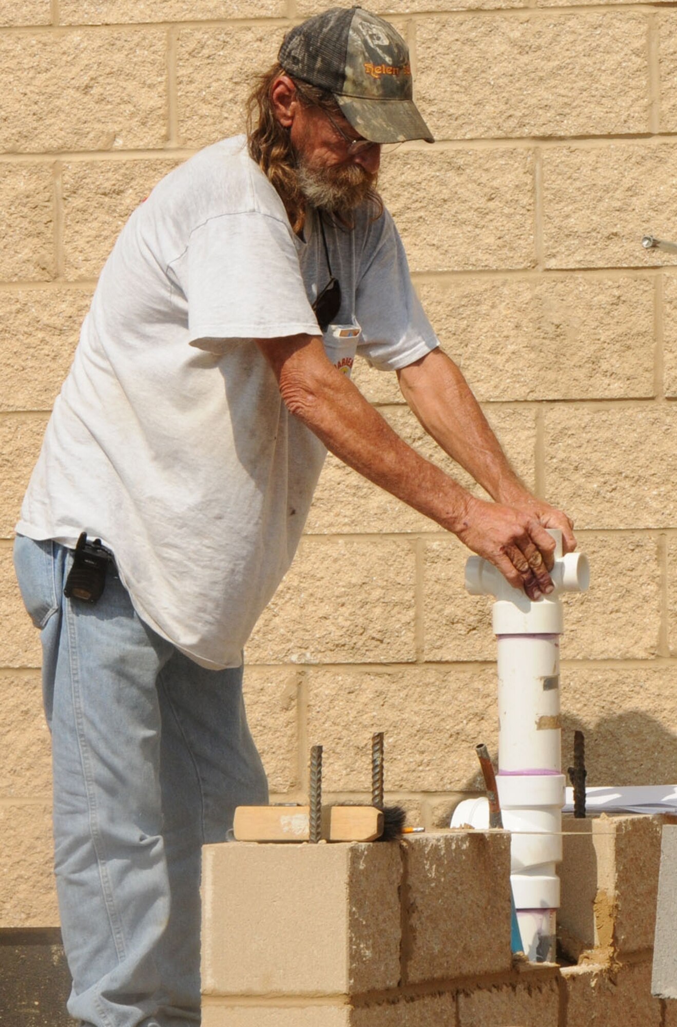 Plumbing contractor Charles Johnson cements a PVC pipe joint in place on the construction site of Duke Field’s new field house May 9.   Expected to be complete by early fall, the facility located alongside the base running track will include showers, locker rooms and restrooms in a convenient location for those working out at the base’s fitness complex. (U.S. Air Force photo/Adam Duckworth)