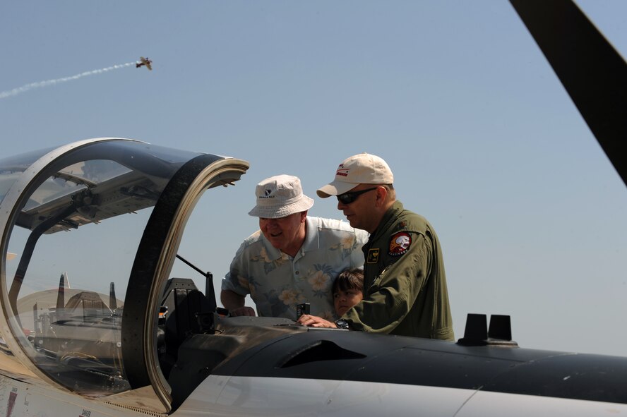 Retired Air Force Maj. Gen. James Graves and Arianne Graves, 8, take a closer look at a T-6A Texan II with Maj. Byron Dobbs, Air Education Training Command, during the 2011 Defenders of Liberty Air Show on Barksdale Air Force Base, La., May 7. The T-6 is a single-engine, two-seater plane designed to train student pilots basic flying skills. (U.S. Air Force photo/Airman 1st Class Micaiah Anthony)(RELEASED)