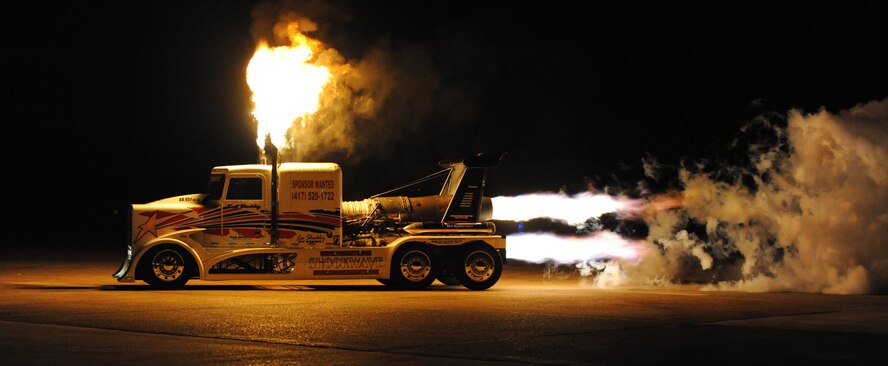 Ray Kinney, driver of the P-40 Shockwave Jet Truck, drives past a crowd during the Twilight Show on Barksdale Air Force Base, La., May 6. The Twilight Show was a special demonstration for military members and their families to enjoy prior to the Defenders of Liberty Air Show, which was open to the public May 7 and 8. (U.S. Air Force photo/Airman 1st Class Micaiah Anthony) (RELEASED)