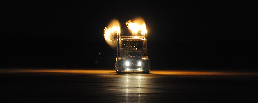 Ray Kinney, driver of the P-40 Shockwave Jet Truck, drives towards a crowd during the Twilight Show on Barksdale Air Force Base, La., May 6. The Twilight Show was a special demonstration for military members and their families to enjoy prior to the Defenders of Liberty Air Show, which was open to the public May 7 and 8. (U.S. Air Force photo/Airman 1st Class Micaiah Anthony) (RELEASED)