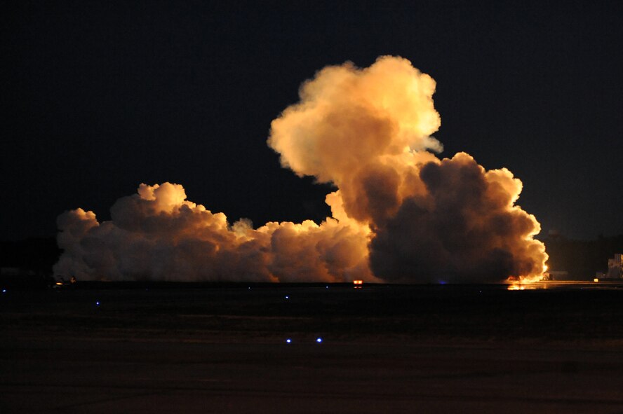 Ray Kinney, driver of the P-40 Shockwave Jet Truck, makes a cloud of smoke during the Twilight Show on Barksdale Air Force Base, La., May 6. The Twilight Show was a special demonstration for military members and their families to enjoy prior to the Defenders of Liberty Air Show, which was open to the public May 7 and 8. (U.S. Air Force photo/Airman 1st Class Micaiah Anthony) (RELEASED)