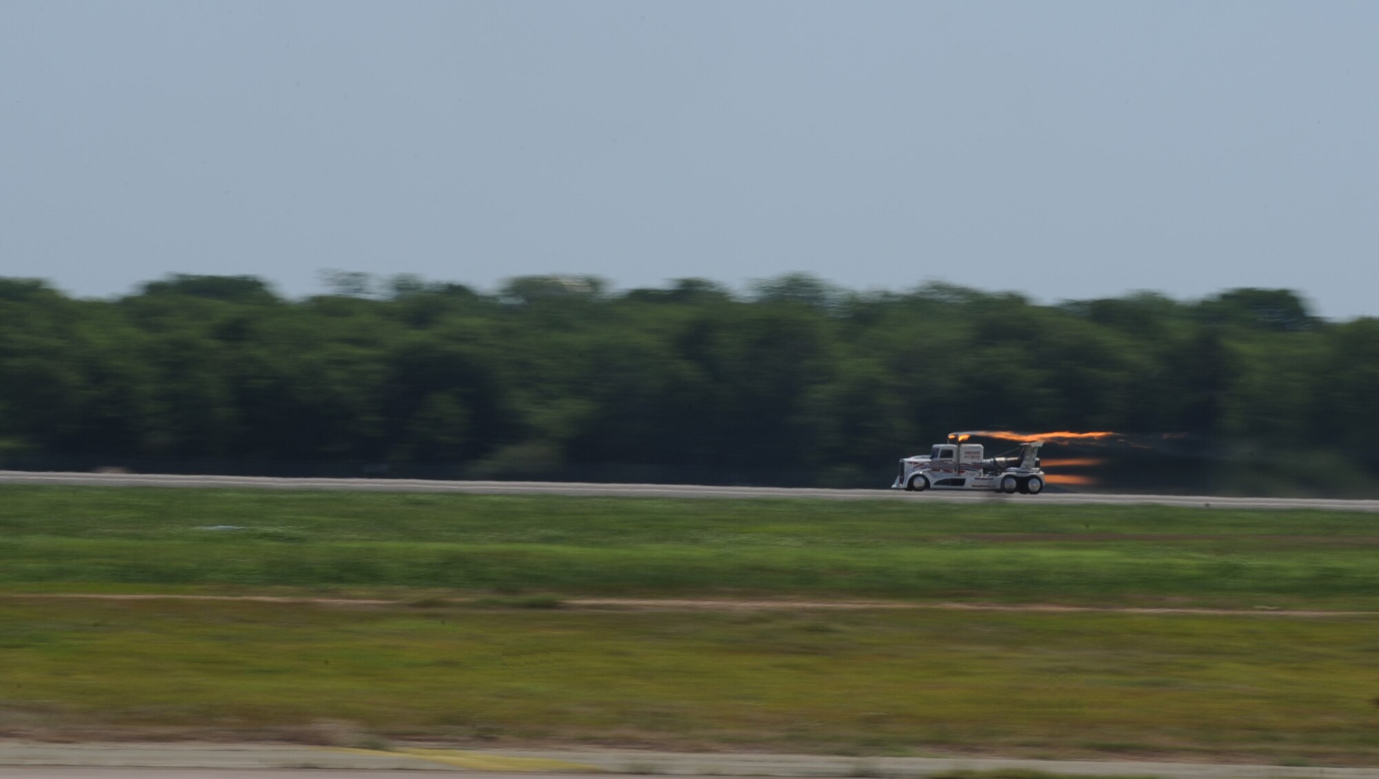 Ray Kinney,driver of the P-40 Shockwave Jet Truck, speeds past a crowd during the 2011 Defenders of Liberty Air Show on Barksdale Air Force Base, La., May 7. The Shockwave was clocked at 306 miles per hour during its run. Aircraft and parachute demonstrations, static displays and re-enactments were a few events held at this year's air show. (U.S. Air Force photo/Airman 1st Class Micaiah Anthony)(RELEASED)