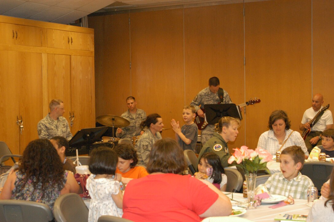 Music was provided for the Deployed Families Dinner by members of the USAF Academy Band, TSgt Andrew Benton, MSgt Chris Gaona, TSgt Julie Bradley, MSgt Jeremy Laukhuf, and SMSgt (ret) Wayne Wilkerson. TSgt Bradley's husband, MSgt Karl Bradley, is also deployed with the USAF Academy Band's Wild Blue Country, and their son Cooper also participated in the music-making, 