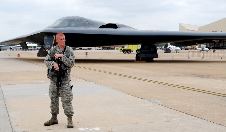 Airman First Class Caleb Gore, 2nd Security Forces Squadron, guards a B-2 Spirit Stealth Bomber during the 2011 Defenders of Liberty Air Show on Barksdale Air Force Base, La., May 8. The B-2 has the capacity to carry up to 40,000 pounds of weapons, including conventional and nuclear weapons. (U.S. Air Force photo/ Senior Airman Kristin High)(RELEASED)