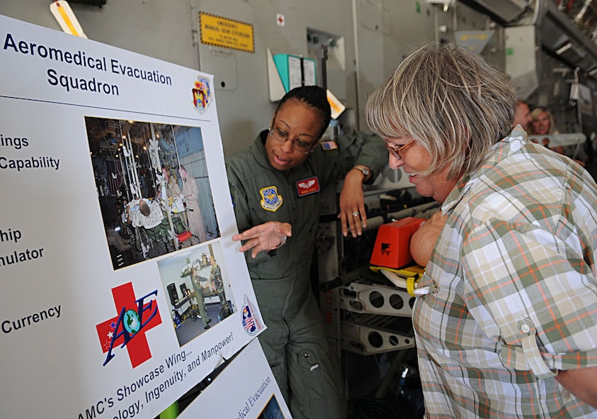 Maj. Wanda Parks, 375th Aeromedical Evacuation Squadron, presents a display to Barbara Pourteau at the 2011 Defenders of Liberty Air Show on Barksdale Air Force Base, La., May 7. Major Parks presents the different aspects of her career and explains the importance of her job to air show attendees. (U.S. Air Force photo/ Senior Airman Kristin High)(RELEASED)
