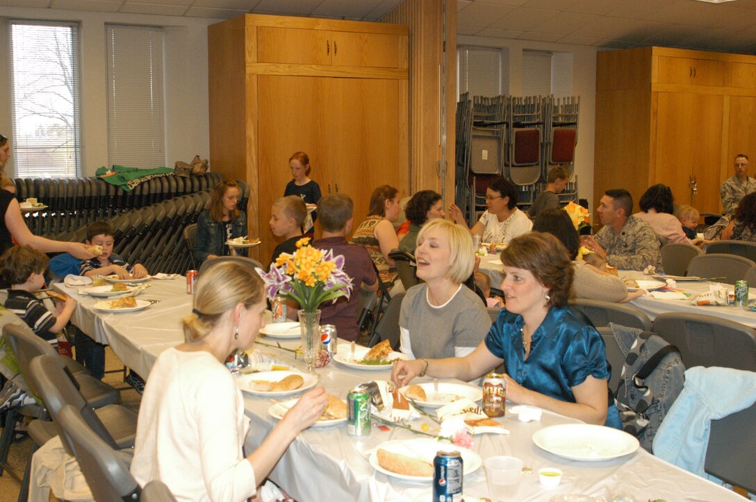 Joanna Masztalerz, Melanie Oddo, and Rachel Brannen enjoy a moment of respite from watching kids at the Deployed Families Dinner. Their spouses are deployed with the USAF Academy Band's Wild Blue Country in SW Asia.