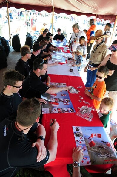 The Canadian Forces Parachute Demo Team, The SkyHawks, sign autographs for attendees of the 2011 Defenders of Liberty Air Show at Barksdale Air Force Base, La., May 7. The SkyHawks kicked-off the first day of the show by presenting the colors during the opening ceremony. (U.S. Air Force photo/Senior Airman Joanna M. Kresge)
