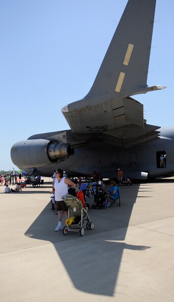 Spectators grab some shade under the wing of a C-17 from Altus Air Force Base, Okla., during the Defenders of Liberty Air Show at Barksdale AFB, La., May 7. More than 180,000 people were expected at this year's show and the weather was clear and sunny. (U.S. Air Force photo/Staff Sgt. John Gordinier) (Released)