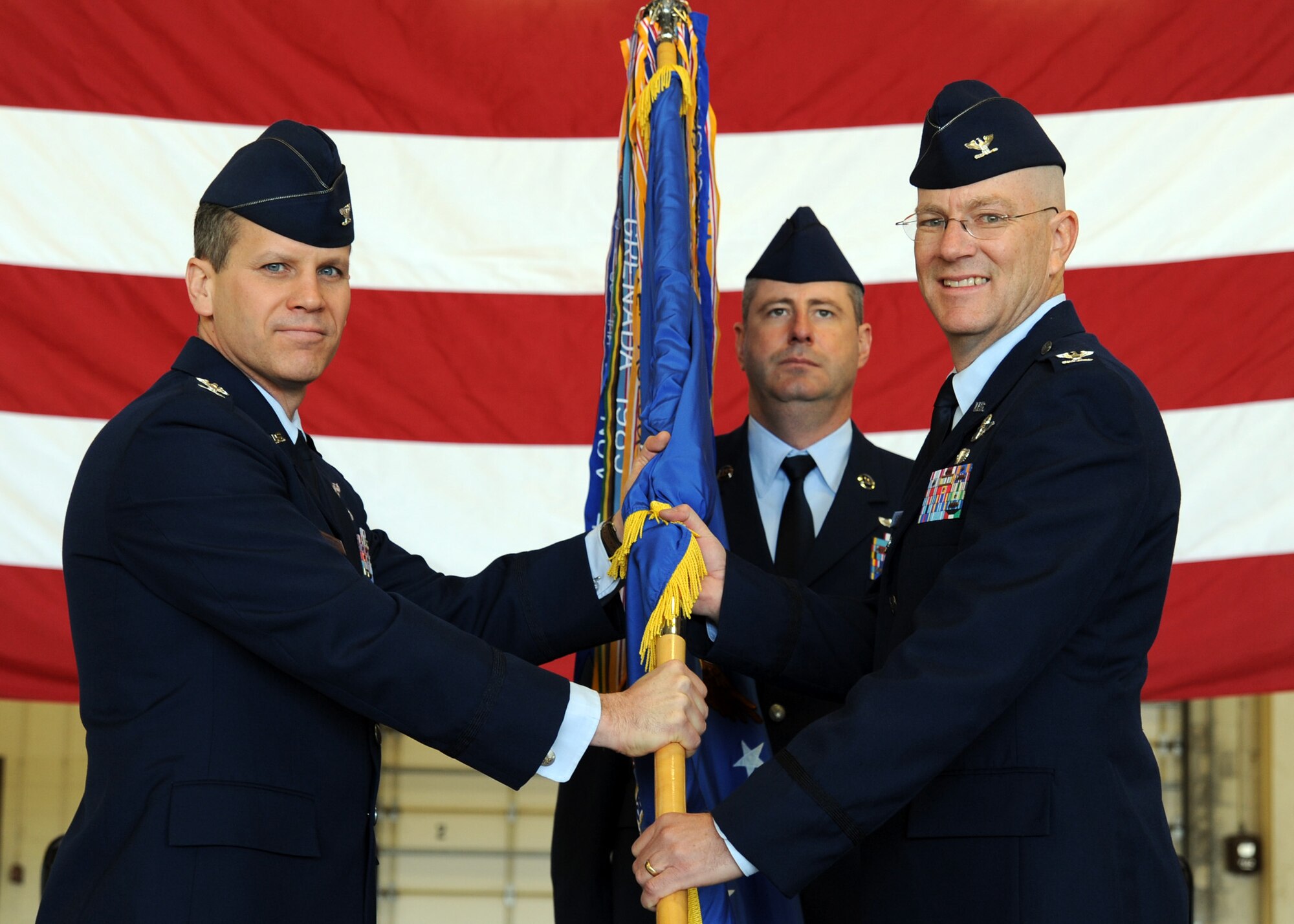 Col. Jamie Crowhurst, 22nd Air Refueling Wing commander, hands the guidon to Col. Thomas Riney, 22nd Operations Group commander, during a change of command ceremony May 3, 2011, McConnell Air Force Base, Kan. The passing of the guidon symbolizes Colonel Riney assuming command from the outgoing commander, Col. Ron Langford. (U.S. Air Force photo/Staff Sgt. Dallas Edwards)