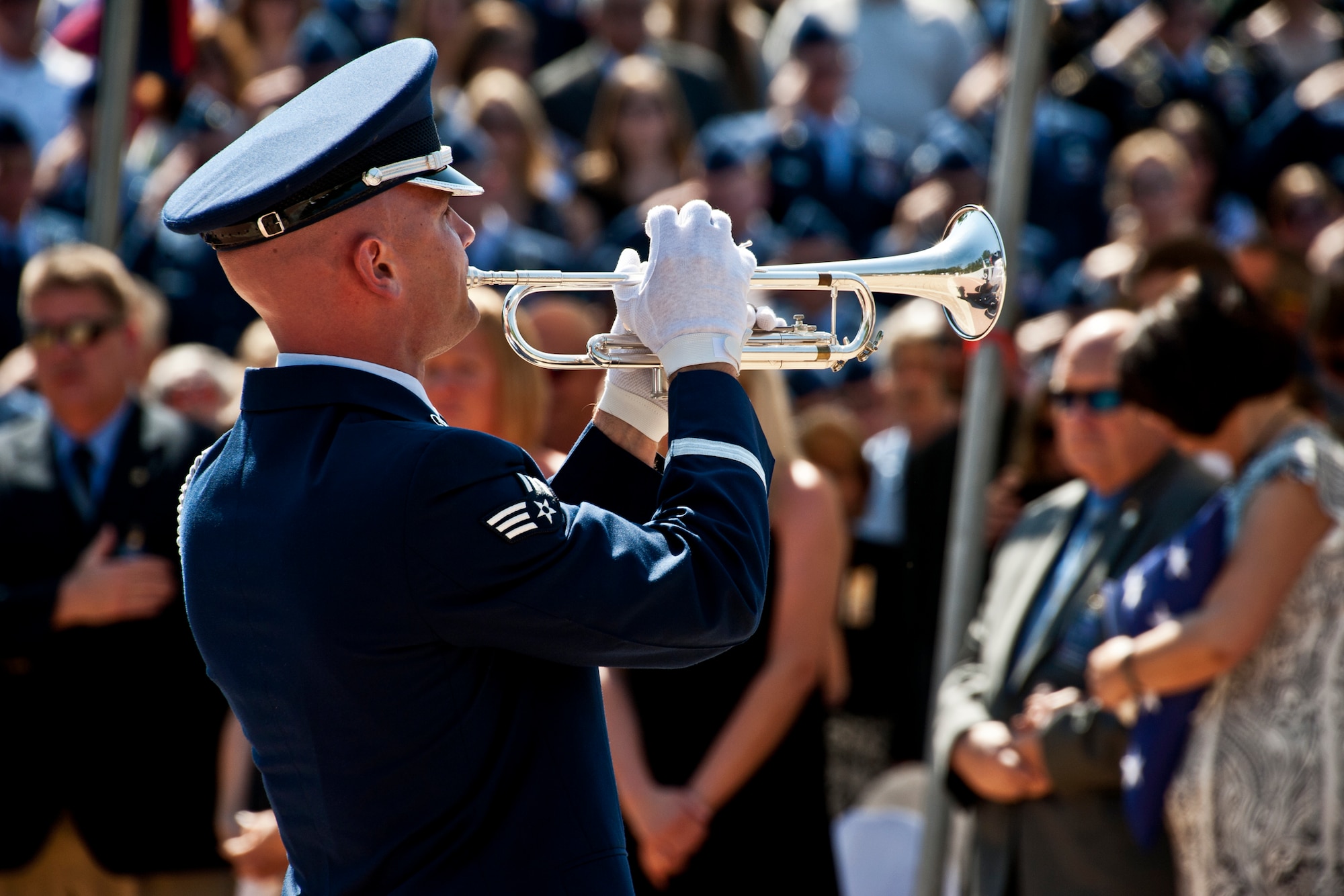 Senior Airman Nicholas Cooper, 96th Air Base Wing honor guard, closes the Explosive Ordnance Disposal Memorial ceremony by playing Taps May 7 at Eglin Air Force Base, Fla.  Fifteen new names were added to the memorial wall this year.  The total, which includes all services, now stands at 269.  (U.S. Air Force photo/Samuel King Jr.)