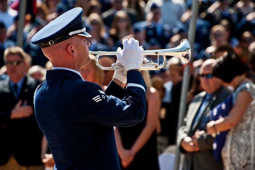 Senior Airman Nicholas Cooper, 96th Air Base Wing honor guard, closes the Explosive Ordnance Disposal Memorial ceremony by playing Taps May 7 at Eglin Air Force Base, Fla.  Fifteen new names were added to the memorial wall this year.  The total, which includes all services, now stands at 269.  (U.S. Air Force photo/Samuel King Jr.)