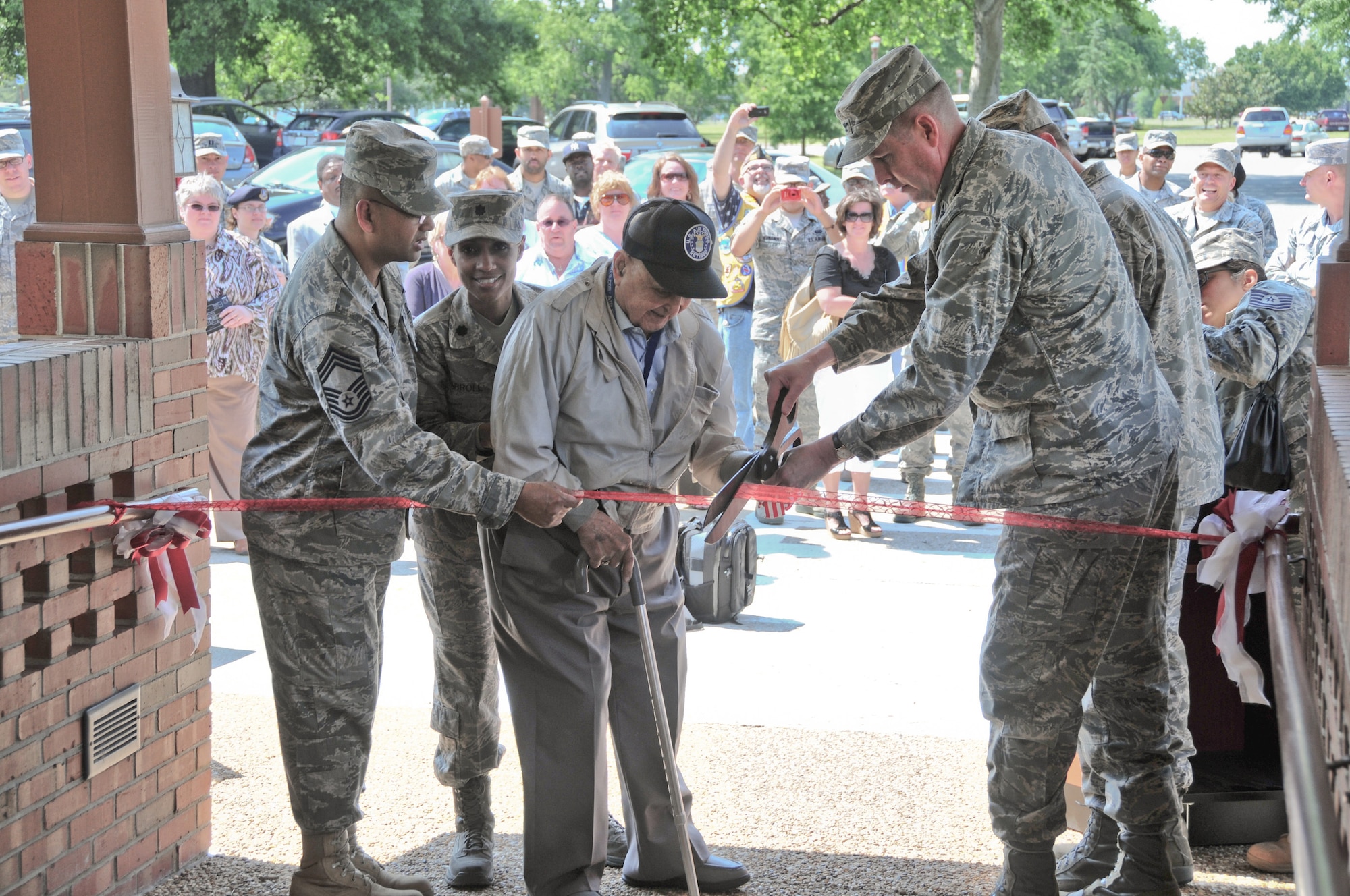 Chief Master Sgt. John Petain, 633d Force Support Squadron superintendent, Lt. Col. Jenise Carroll, 633d FSS commander, retired Chief Master Sgt. Gabriel "Bill" Christie, U.S. Air Force charter chief, and Col. Donald Kirkland, 633d Air Base Wing commander, conduct a ribbon-cutting ceremony for the grand opening of the Langley Club May 6, 2011 at Langley Air Force Base, Va. The Langley Club consolidates the enlisted and officers clubs' common heritage, and highlights shared success and professionalism. (U.S. Air Force Photo/Eric Deagle/released)